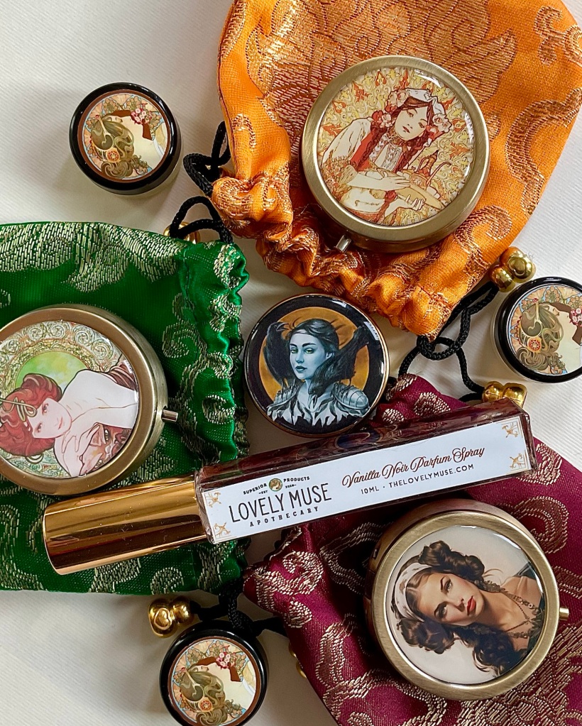 An assortment of lockets, tins, perfume samples and spray perfumes from The Lovely Muse Apothecary
